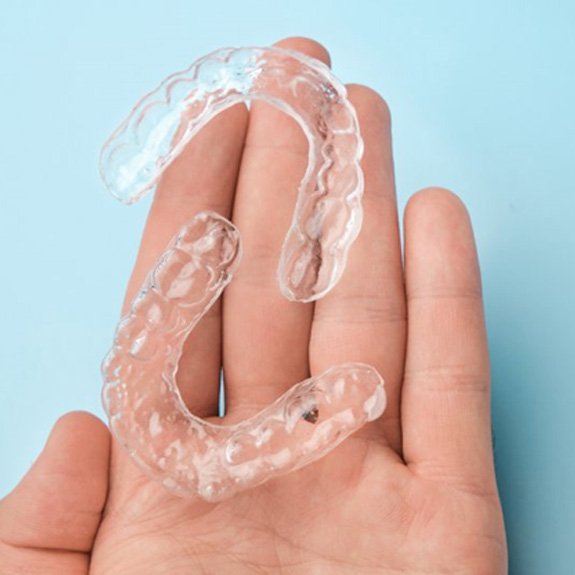 a person in Dublin holding clear aligners