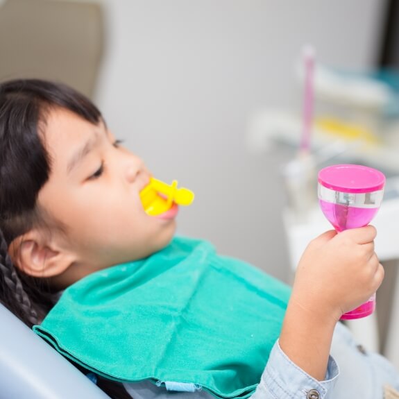 Child receiving fluoride treatment