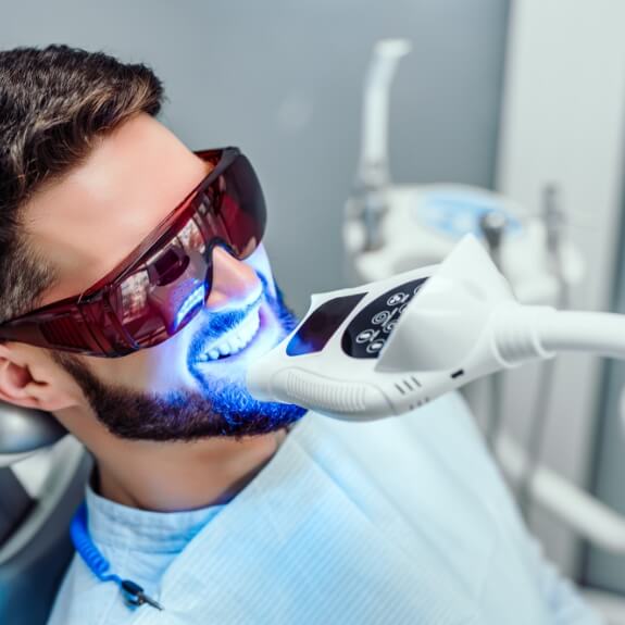 Dental patient receiving in office teeth whitening