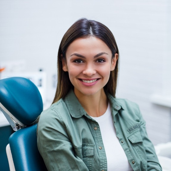 Woman sharing smile as dentist evaluates esthetic smile components