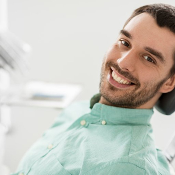 a patient smiling before undergoing a dental checkup