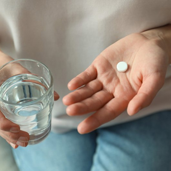  a person preparing to take a pill