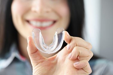 a person holding a mouthguard