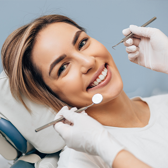 Woman smiling during oral cancer screening