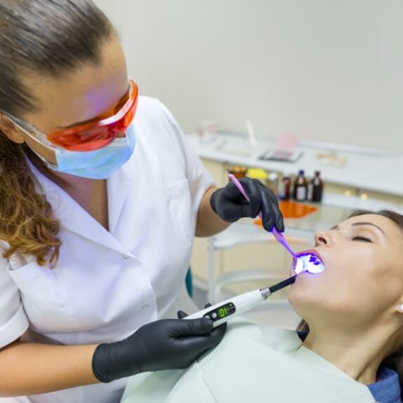 Person receiving dental treatment under oral conscious sedation dentistry treatment