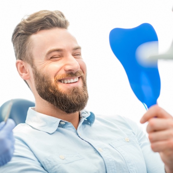 Man looking at smile during cosmetic treatment planning