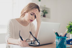 Stressed woman at her computer