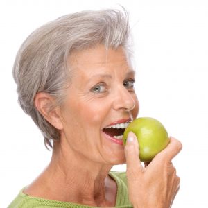 woman preparing to bite into apple