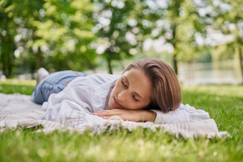 a woman enjoying some sleep outside during summer