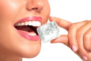 woman mouth open to eat ice