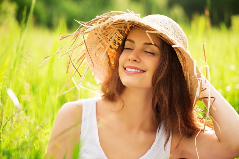 Smiling woman sitting in meadow