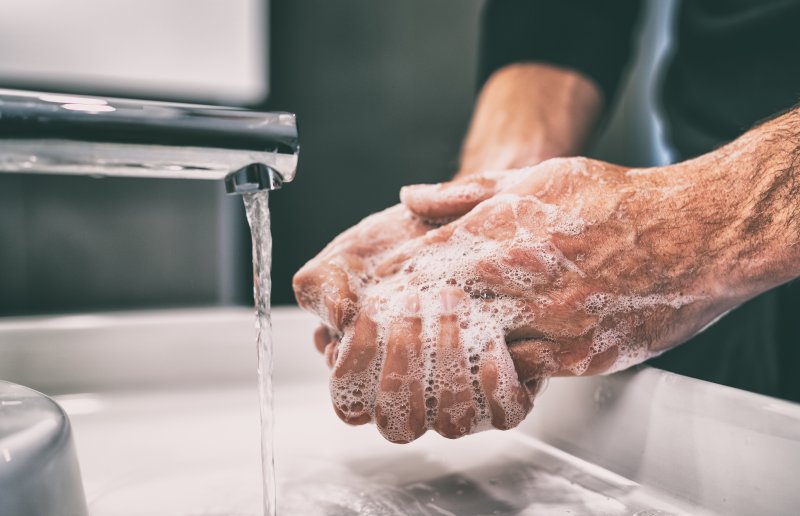 woman washing hands as directed by your dentist in Dublin