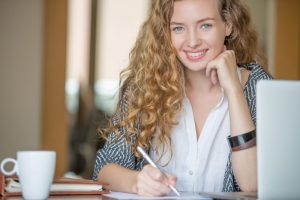 attractive woman at desk smiling