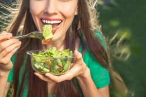 woman eats foods recommended by dentist in Dublin