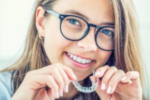 young woman inserting Invisalign in Dublin