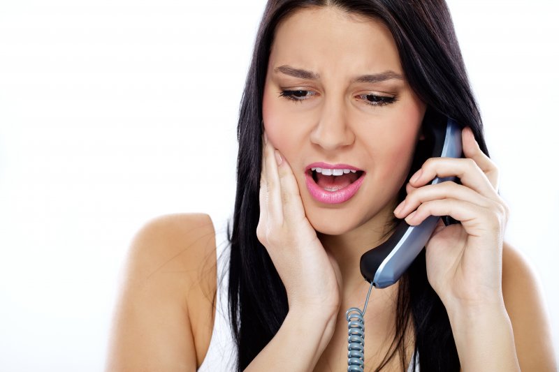 woman with toothache calling emergency dentist in Dublin